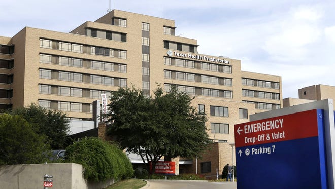 A sign points to the entrance to the emergency room at Texas Health Presbyterian Hospital Dallas, where U.S. Ebola patient Thomas Eric Duncan was being treated, in this Oct. 8 file photo. Health officials said Sunday a health care worker at Texas Health Presbyterian Hospital who provided care for Duncan has tested positive for Ebola in a preliminary test.