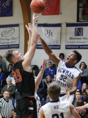 Newman Central Catholic's Marcus Williams goes for a jump ball against Kewanee's Blaine Pickering in last season's meeting in Sterling.