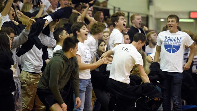Castle students erupt after a 3 pointer by Jack Nunge during the first quarter of the SIAC boys championship game against Memorial at Harrison High School in Evansville Saturday.  Castle claimed its second straight SIAC championship with a 70-52 win over Memorial.