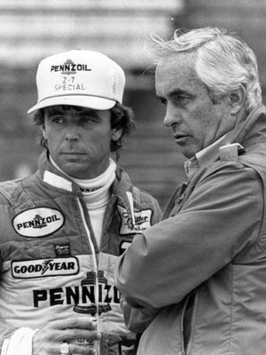 Rick Mears and his car owner Roger Penske watch pit activity during practice in 1984.