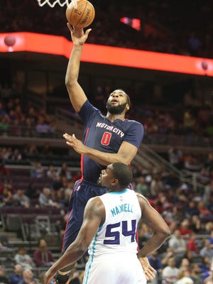 Detroit Pistons center Andre Drummond scores against the Charlotte Hornets' Jason Maxiell during the third period on Sunday, April 12,2015 at The Palace of Auburn Hills.