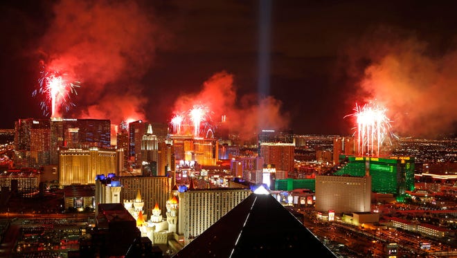 FILE - In this Jan. 1, 2015, file photo, fireworks explode above the Strip to ring in the new year in Las Vegas. Tens of thousands of revelers will ring in the New Year in Las Vegas under the close eye of law enforcement just three months after the deadliest mass shooting in modern U.S. history. The Las Vegas Metropolitan Police Department will have every officer working Sunday, Dec. 31, 2017, while the Nevada National Guard is activating about 350 soldiers and airmen. (AP Photo/John Locher, File)