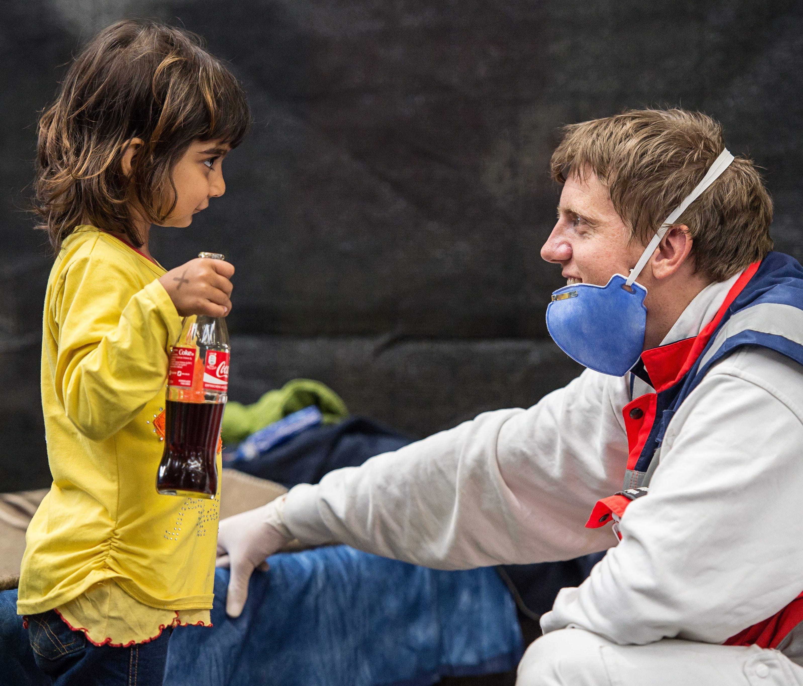 A volunteer from the German Red Cross plays with Zena, a little girl from Syria, in an emergerncy shelter in Rottenburg, Germany, on Sept. 16, 2015.