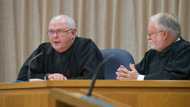 Judge Edward P. Nickinson, right, listens as Judge Patt Maney speaks during the graduation ceremony of the first class of Escambia Veterans' Court held at the M.C. Blanchard Judicial Building in Pensacola, FL on Tuesday, September 13, 2016.