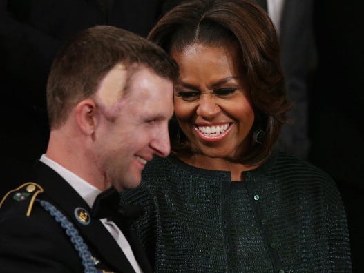 
First lady Michelle Obama stands with U.S. Army Ranger Sgt. First Class Cory Remsburg before U.S. President Barack Obama delivers the State of the Union address Jan. 28.

