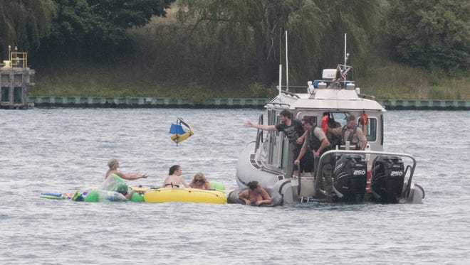 A U.S. Border Protection boat helps floaters on the St. Clair River.