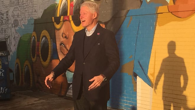 Former President Bill Clinton takes a tour through Eastern Market Friday.