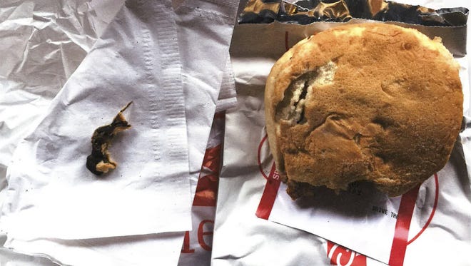 This Nov. 25, 2016, photo provided by Ellen Manfalouti, of Holland, Pa., shows the remains of a rodent, left, she alleges she found baked into the bun of a chicken sandwich, right, that a co-worker purchased for her that day at a Chick-fil-A franchise restaurant in Langhorne, Pa. Manfalouti, a suburban Philadelphia woman, sued in Bucks County Court in August 2017 over the rodent she claims was baked into the bottom bun of her chicken sandwich. (Ellen Manfalouti via AP)