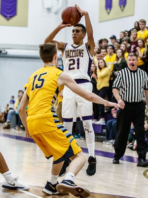 Oconomowoc senior Dominic Briggs (21) goes up for three during the game at home against Kettle Moraine on Friday, Jan. 26, 2018.