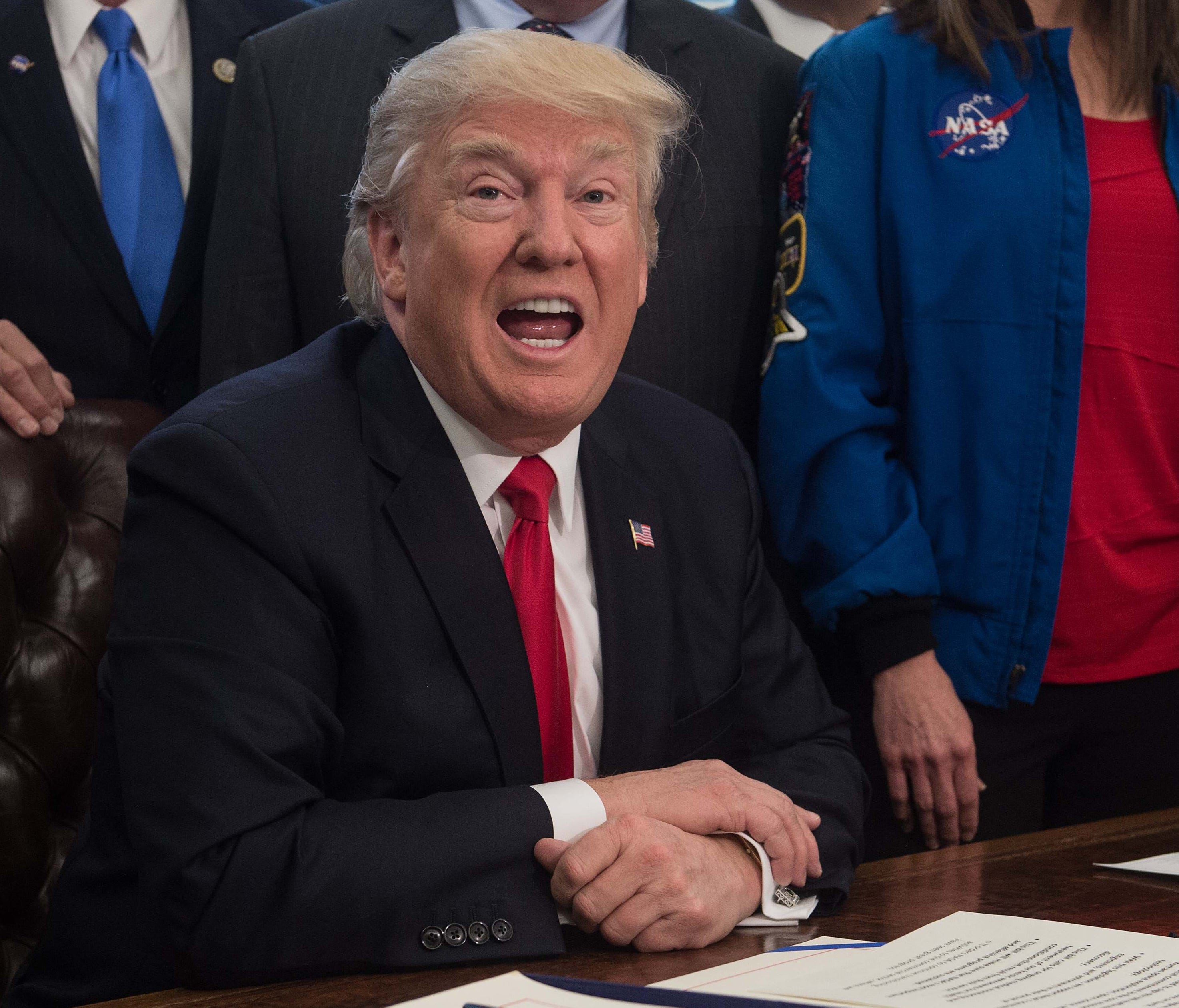US President Donald Trump speaks before signing a bill increasing funding for NASA in the Oval Office at the White House in Washington, DC, on March 21, 2017. / AFP PHOTO / NICHOLAS KAMMNICHOLAS KAMM/AFP/Getty Images ORIG FILE ID: AFP_MV1XO