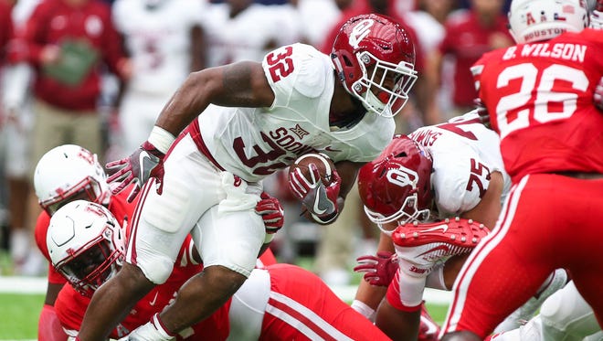 Oklahoma running back Samaje Perine had his game interrupted Saturday by an amazing tackle by Houston safety Garrett Davis.