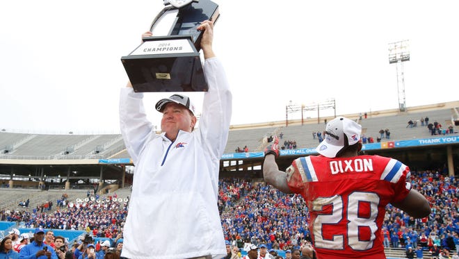 Louisiana Tech coach Skip Holtz holds up the trophy after last year's win over Illinois in the Heart of Dallas Bowl. The Bulldogs will play Arkansas State this year in the New Orleans Bowl.