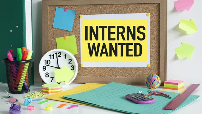 Interns wanted sign note on cork bulletin board.