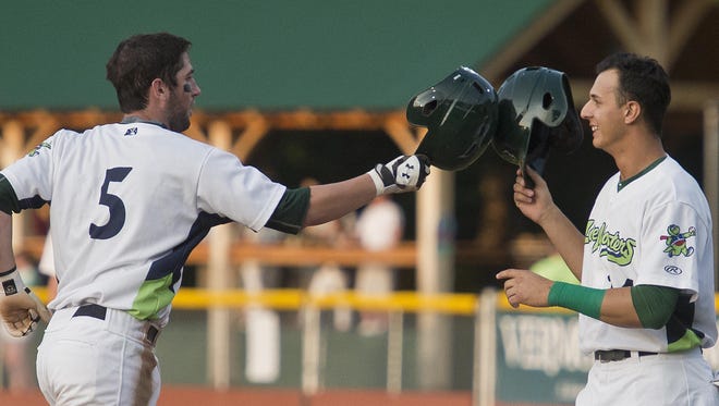 Vermont’s Mikey White (5) and Steven Pallares tip their helmets to each other after White hit a three-run homer in the second inning against the Mahoning Valley Scrappers on Wednesday night at Centennial Field.