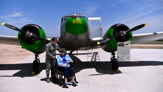 Senior Airman Tiffany Schockley of Dyess Air Force Base waits with Dorothy Lucas in front of a Cessna UC-78 Bobcat on May 6 at the WASP Homecoming in Sweetwater. Lucas was a member of the Women's Airforce Service Pilots and trained at Avenger Field in 1944.