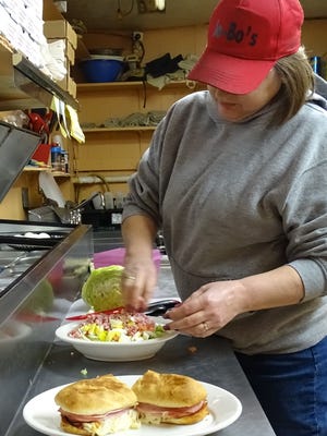 JoBo's Manager Rae Perone prepares a chef salad to compliment the Italian sub sandwich.