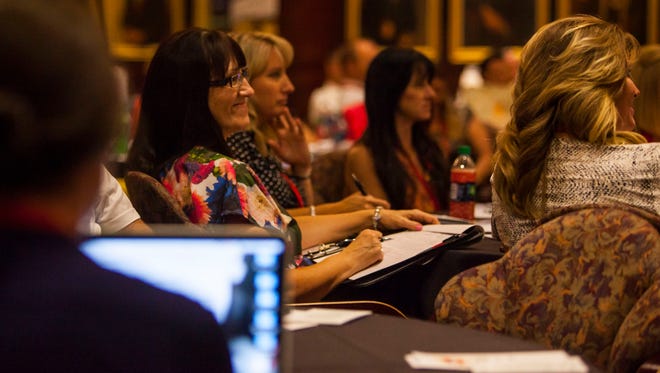 Women take notes during a speech at the Much Ado About Business retreat at Southern Utah University, Thursday, July 21, 2016.