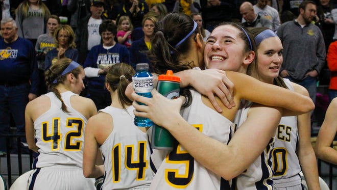 Pewamo-Westphalia 's Kylen Pohl hugs teammate Kiera Thelen, right,  after the Pirates beat Maple City Glen Lake Thursday, March 16, 2017, during the Class B Semifinal at the Breslin in East Lansing.  P-W won 64-51.