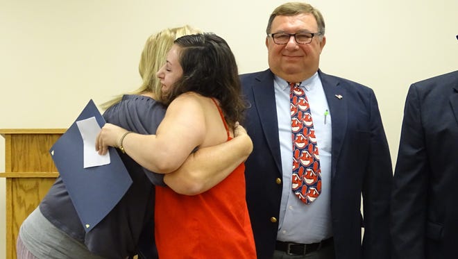 After receiving her certificate signifying her graduation from Mental Health Court Wednesday, Latosha Connolly hugs Mental Health Court Senior Probation Officer Kim  Romoser.