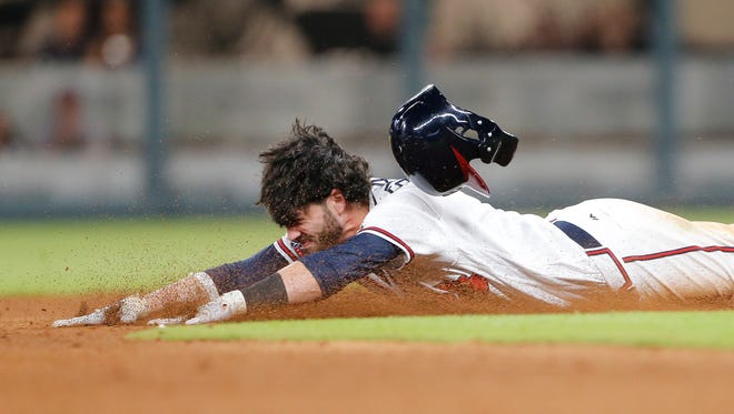 Atlanta Braves' Dansby Swanson (7) dives in to second base with a double in the ninth inning against the New York Mets Friday, June 9, 2017.