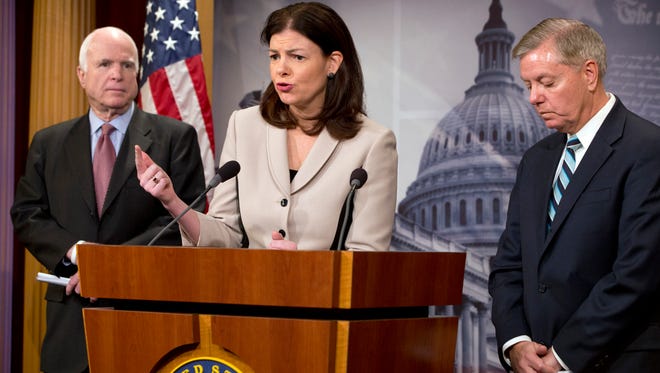 Sen. Kelly Ayotte (center), R-N.H., flanked by Senate Armed Services Committee Chairman Sen. John McCain (left), R-Ariz., and Sen. Lindsey Graham, R-S.C., speaks during a news conference on Capitol Hill in Washington on Tuesday, Jan. 13, 2015, to discuss the federal prison at Guantanamo Bay, Cuba.