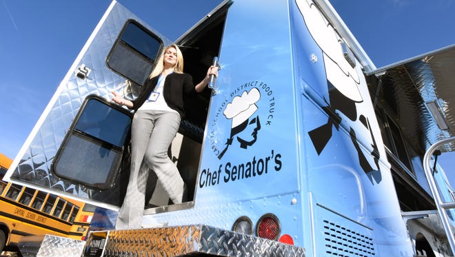In this 2017 file photo, Brittany Adams, nutritionist for the Capital School District, in Dover is shown with the new food truck for The Capital School District. The truck was utilized to provide free meals for the summer food program.