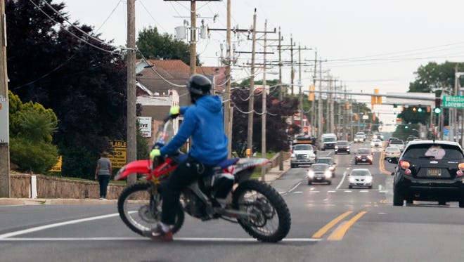 An unregistered dirt bike rider turns around on Maryland Avenue near Elsmere after riding from Wilmington Tuesday, June 12, 2018.