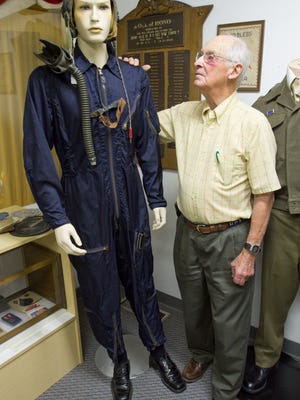 Dick Moehl stands next to a flight suit Moehl wore as a gunner in a B-29 while serving in the Korean War. Moehl has donated that suit and his Boy Scout uniform, as well as a few other items to the Hamburg Historical Museum.