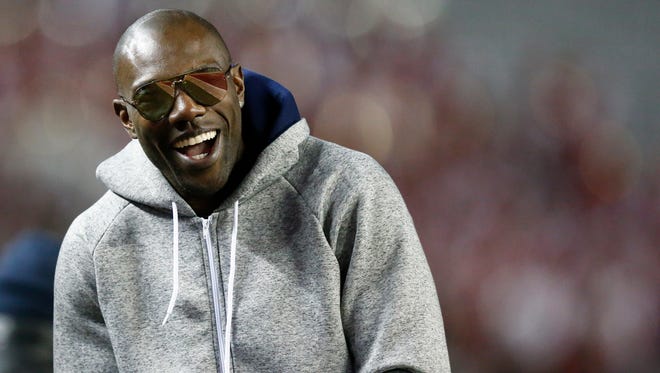 Former NFL wide receiver and Chattanooga alum Terrell Owens walks the sidelines during the second half of an NCAA college football game with Alabama and Chattanooga, Saturday, Nov. 19, 2016, in Tuscaloosa, Ala.