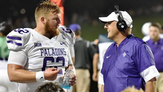 Senior Matthew Schmidt (62)is one of the experienced lineman Furman coach Clay Hendrix, right, is counting on to lead the Paladins against N.C. State today.