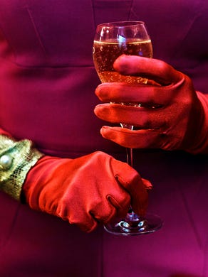 A woman holds a drink during a viewing party of the royal wedding of Meghan Markle and Prince Harry of Wales, at the Plaza Hotel on Saturday, May 19, 2018, in New York. (AP Photo/Andres Kudacki)