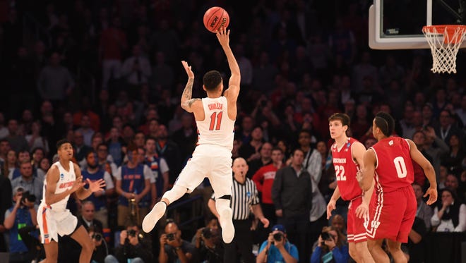 Florida Gators guard Chris Chiozza (11) makes a three point basket to beat the Wisconsin Badgers in overtime in the semifinals of the East Regional of the 2017 NCAA Tournament at Madison Square Garden.