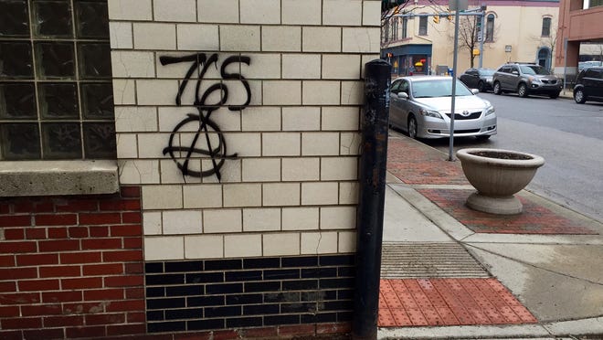 A wall near Columbia and Fourth streets in Lafayette bears graffiti markings suggestive of the “765 Anarchists” group. Police announced Wednesday, March 25, that they’ve been responding to a rash of recent graffiti reports in the area.