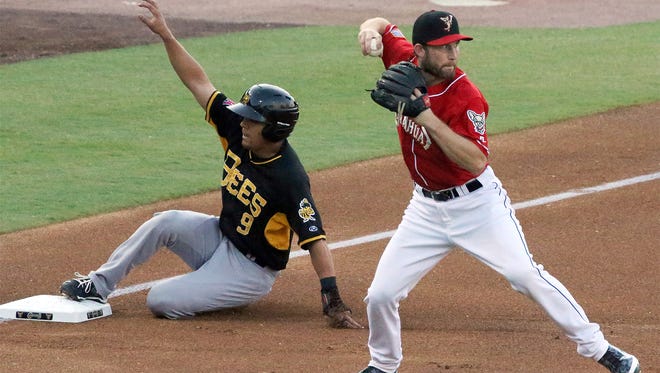 Chihuahuas third baseman Rock Gale looks to throw to second base as Rafael Ortega of the Salt Lake Bees slides safely into third base Wednesday night.