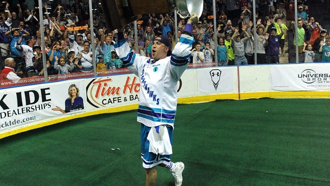 Irondequoit graduate and Knighthawks veteran Joe Walters hoists the NLL championship trophy last spring at Blue Cross Arena after Rochester won its third straight title.