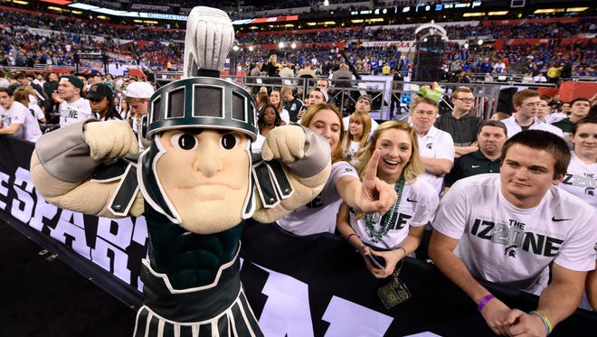 Michigan State Spartans mascot Sparty poses with the student section before the semifinals of the 2015 Final Four of the NCAA Tournament against the Duke Blue Devils at Lucas Oil Stadium.