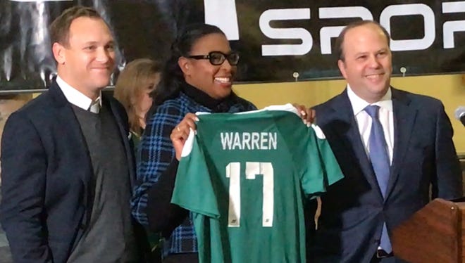 Jason Arnold of Capelli Sport, left, and Rhinos owner David Dworkin pose with Mayor Lovely Warren at Tuesday's announcement that Rochester's downtown soccer park will now be called Capelli Sport Stadium. The City of Rochester owns the facility. The Rhinos run it.