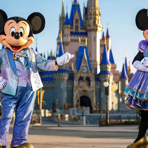 Mickey and Minnie in front of the Magic Kingdom ca