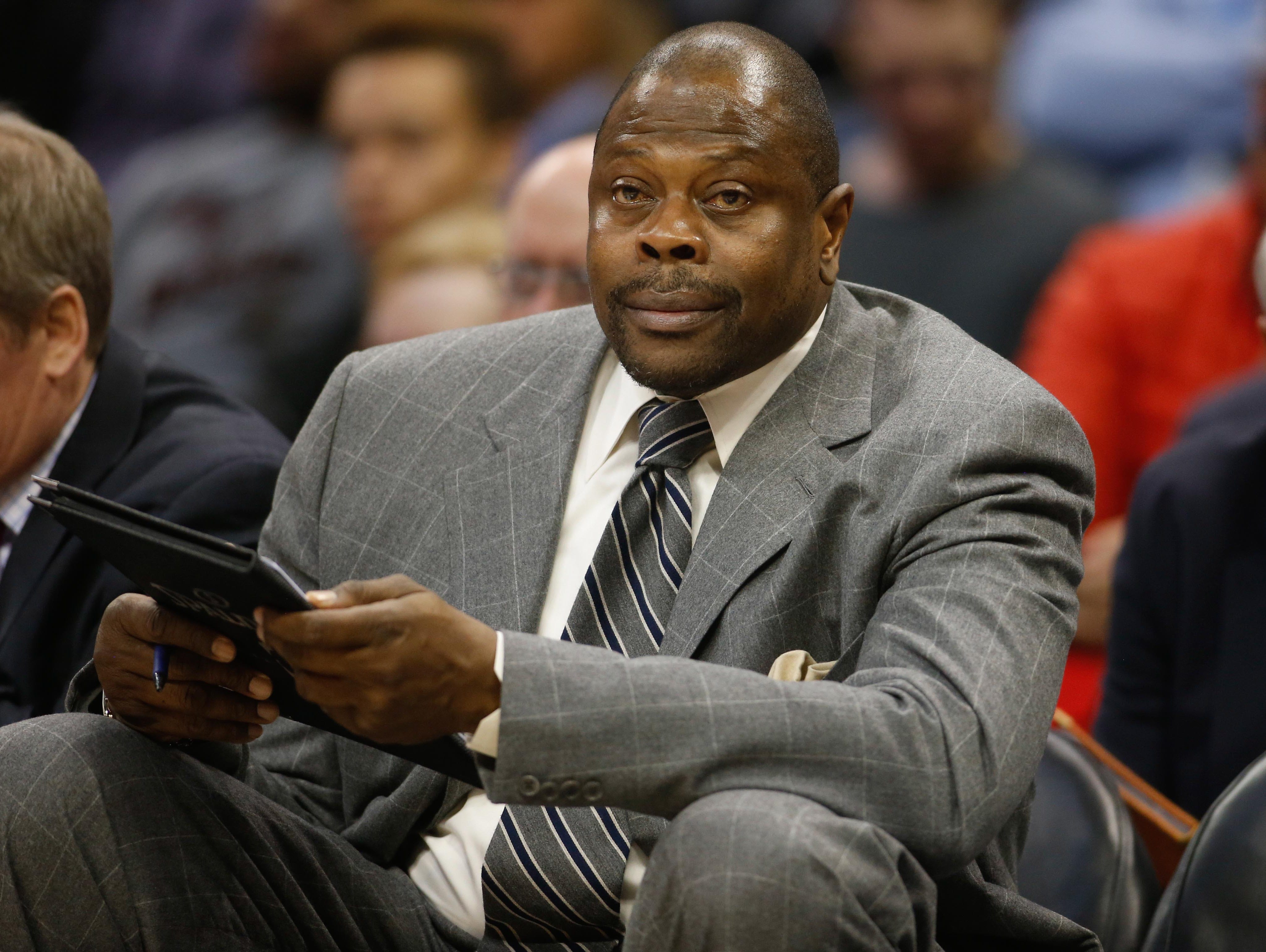 Charlotte Hornets assistant coach Patrick Ewing sits on the bench during a game against the Denver Nuggets.