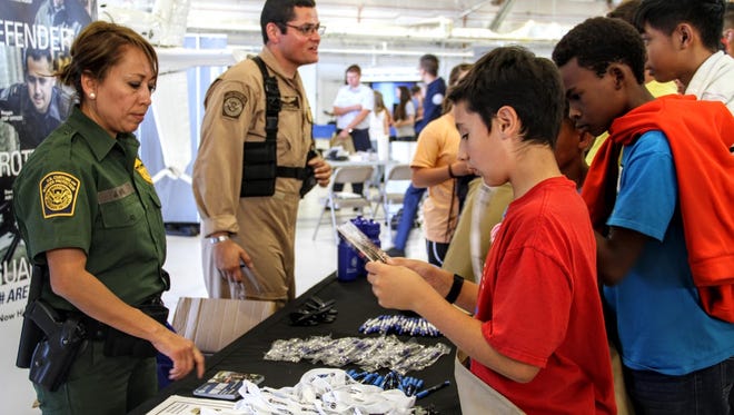 Members of the U.S. Customs and Border Patrol provide information to students about their career at Holloman Air Force Base Thursday monring.