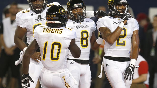 Grambling State wide receiver Verlan Hunter (2) celebrates with Dominique Leake after scoring during the first half of an NCAA college football game against Arizona, Saturday in Tucson, Ariz.