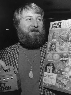 Gary Dahl holds Pet Rock items in 1976.