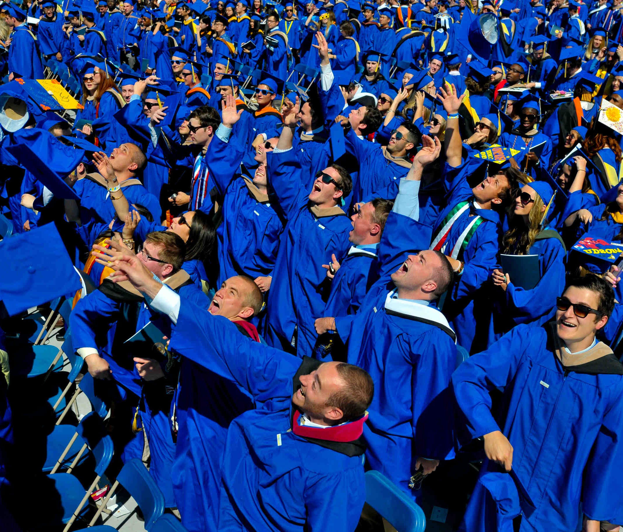 In this May 31, 2014 photo, graduates throw their caps in the air in triumph at the University of Delaware's commencement ceremony in Newark, Del.     (AP Photo/Emily Varisco)