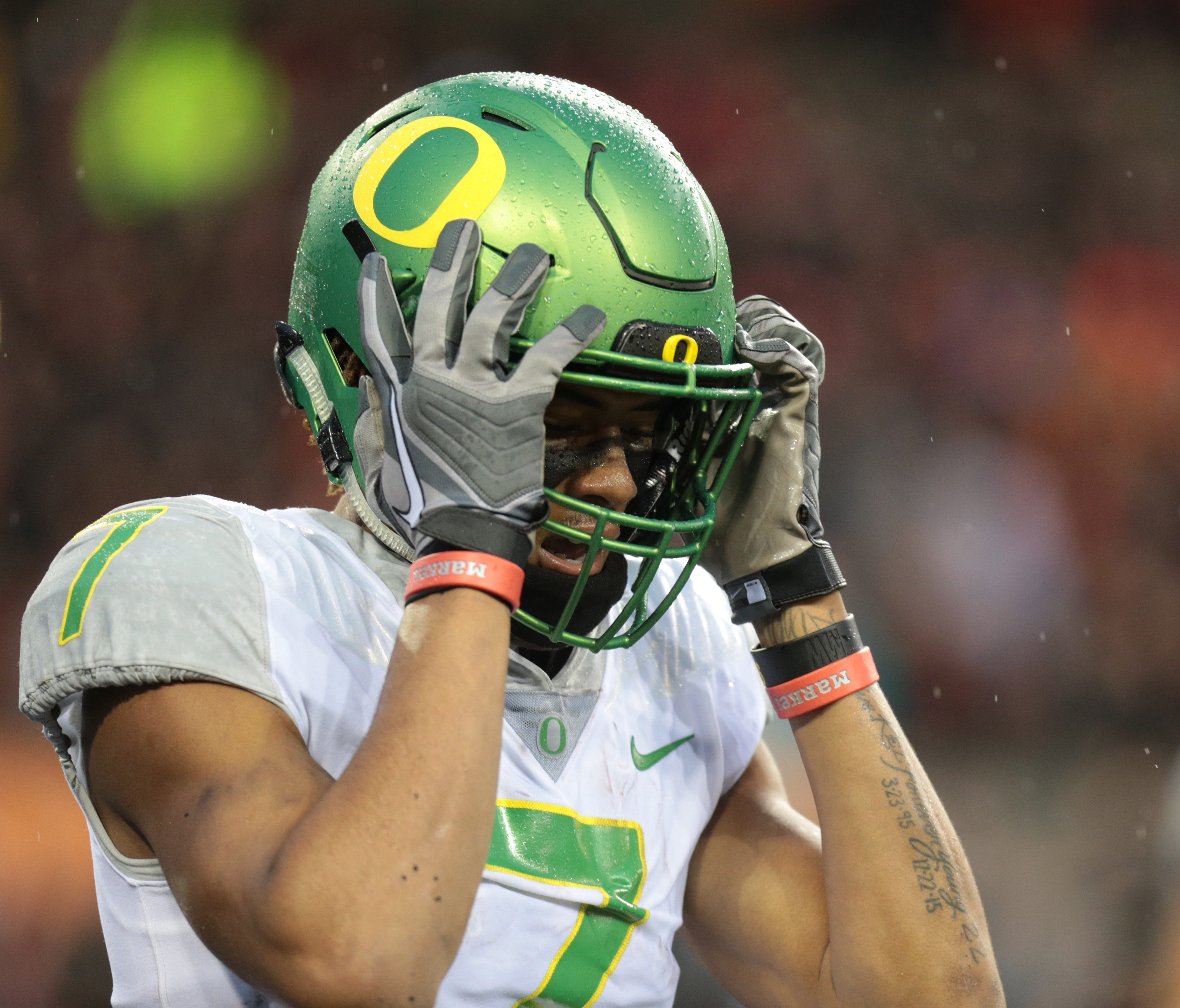 Oregon Ducks wide receiver Darren Carrington II grabs his helmet at the end of a game against the Oregon State Beavers.