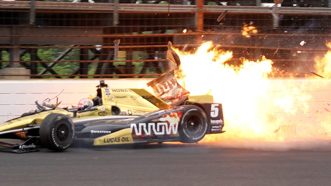 Schmidt Peterson Motorsports driver James Hinchcliffe (5) hits the wall coming out of turn 3 during practice for the 99th Indianapolis 500 Monday, May 18, 2015, morning at the Indianapolis Motor Speedway.