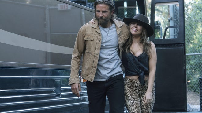 This image released by Warner Bros. Pictures shows Bradley Cooper, left, and Lady Gaga in a scene from "A Star is Born." (Clay Enos/Warner Bros. Pictures via AP)
