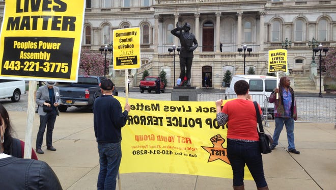 Demonstrators protest the death of Freddie Gray outside Baltimore City Hall on April 20.