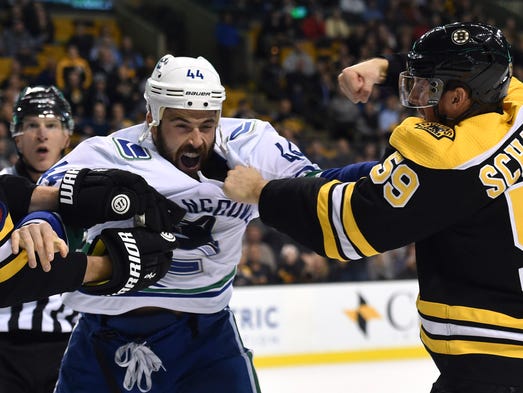 Oct. 19: Bruins center Tim Schaller, right, fights