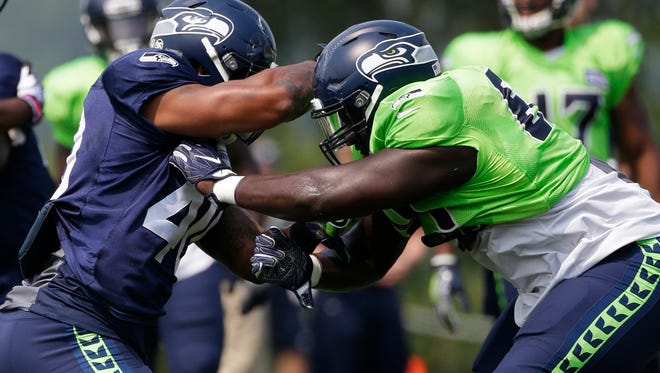 Seahawks defensive tackle Rodney Coe, right, battles fullback Kyle Coleman during training camp in Renton, Wash.