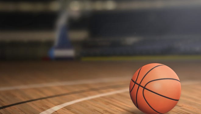 A basketball on a court floor.